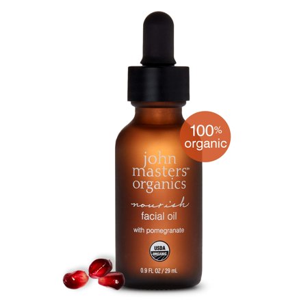 Amber glass bottle with a black dropper cap, labeled "John Masters Organics Pomegranate Facial Nourishing Oil," featuring a USDA Organic seal and a "100% organic" tag.