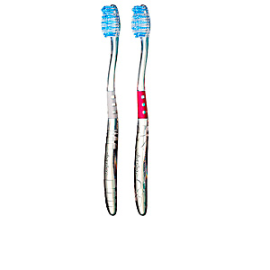 Two medium toothbrushes from Jordan, one with a blue head and white handle, the other with a blue head and red handle, featuring soft bristles and ergonomic grips.