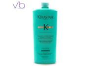Turquoise bottle of Kérastase 34 Conditioner for Women, featuring a sleek design and a flip-top cap, with gold accents and clear labeling.
