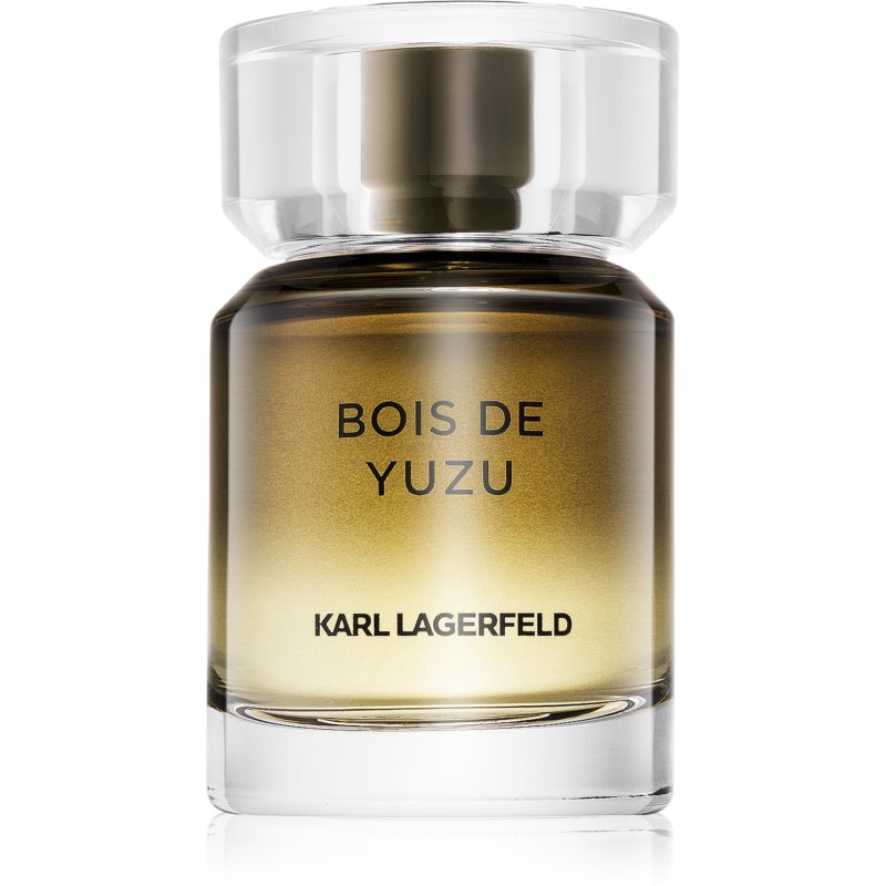 Clear glass bottle with a round, transparent cap; the fragrance is a gradient from gold to amber, featuring "BOIS DE YUZU" and "KARL LAGERFELD" printed in black.