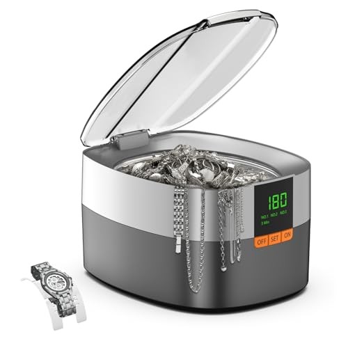 Ultrasonic cleaner with a sleek gray and silver design, featuring a transparent lid, digital display, and a watch alongside various pieces of jewelry inside.
