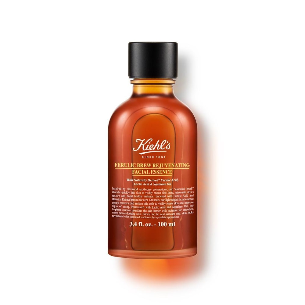 Amber glass bottle with a brown label, featuring "Kiehl's" logo and product name, contains 3.4 fl oz of Ferulic Brew Antioxidant Facial Treatment, showcasing a sleek, modern design.
