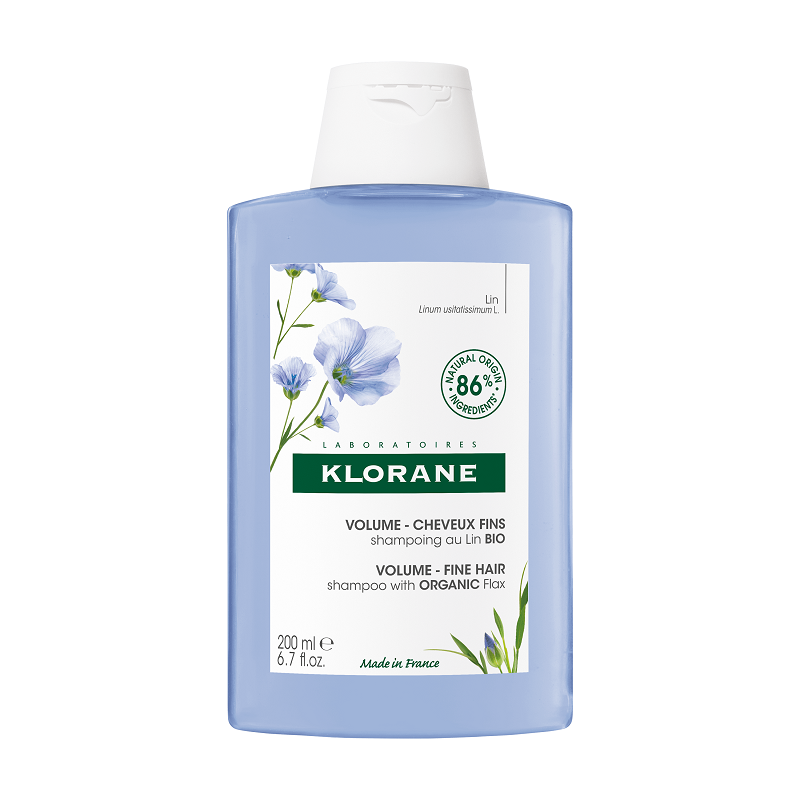 Klorane volumizing shampoo for fine hair in a 200 ml blue plastic bottle, featuring a white flip-top cap and a label with green and floral accents.