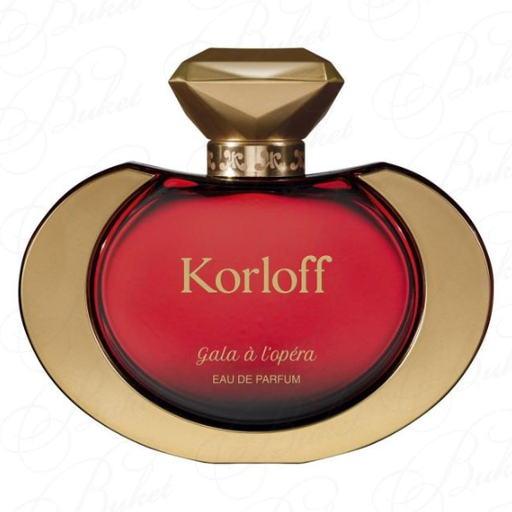 Red glass bottle of Korloff Paris Gala à L'opéra Eau De Parfum, featuring a gold cap shaped like a diamond and elegant gold accents, 3.4 oz size.