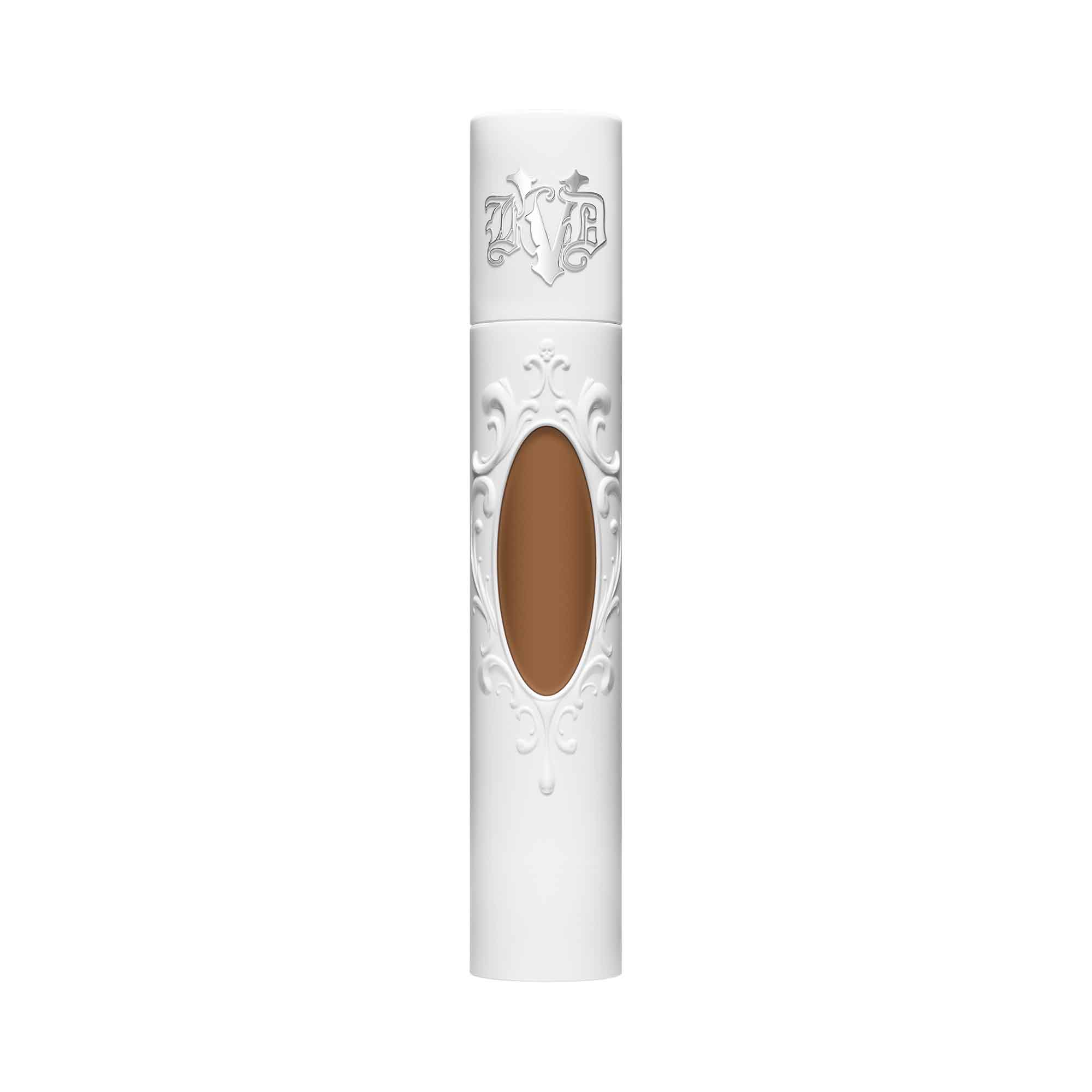 KVD True Portrait 072 Tan Liquid Foundation in a sleek white tube with ornate detailing and a clear window showcasing the tan shade inside, 30ml size.