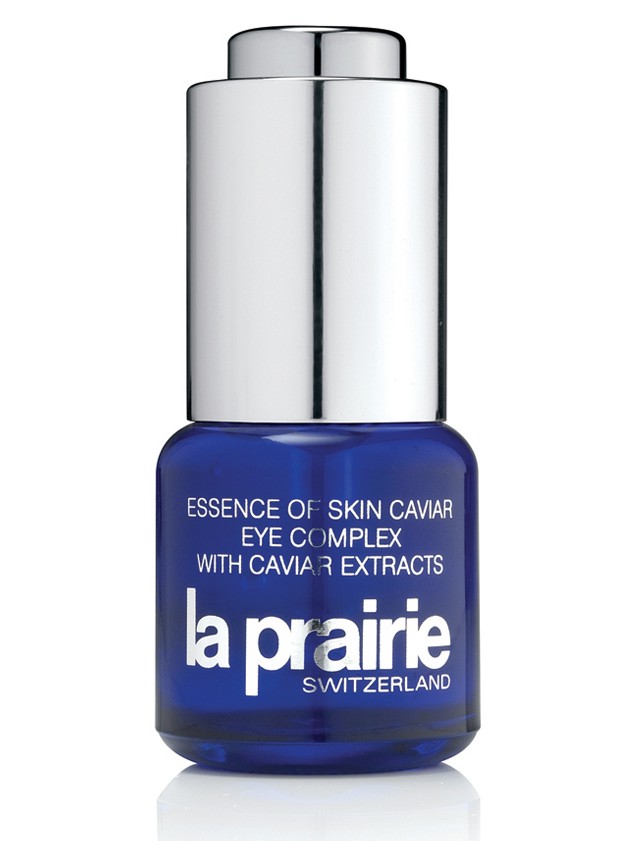Clear glass bottle with a silver cap, featuring a blue label that reads "Essence of Skin Caviar Eye Complex" and "la prairie" in bold white letters, size 15ml.