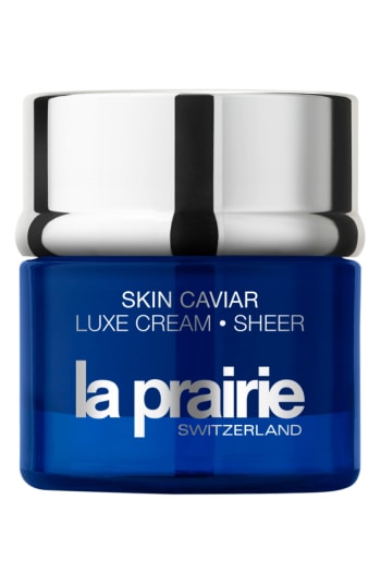 Blue glass jar with a silver lid, labeled "Skin Caviar Luxe Cream • Sheer" and "la prairie SWITZERLAND," containing 50ml/1.7oz of luxurious skincare cream.