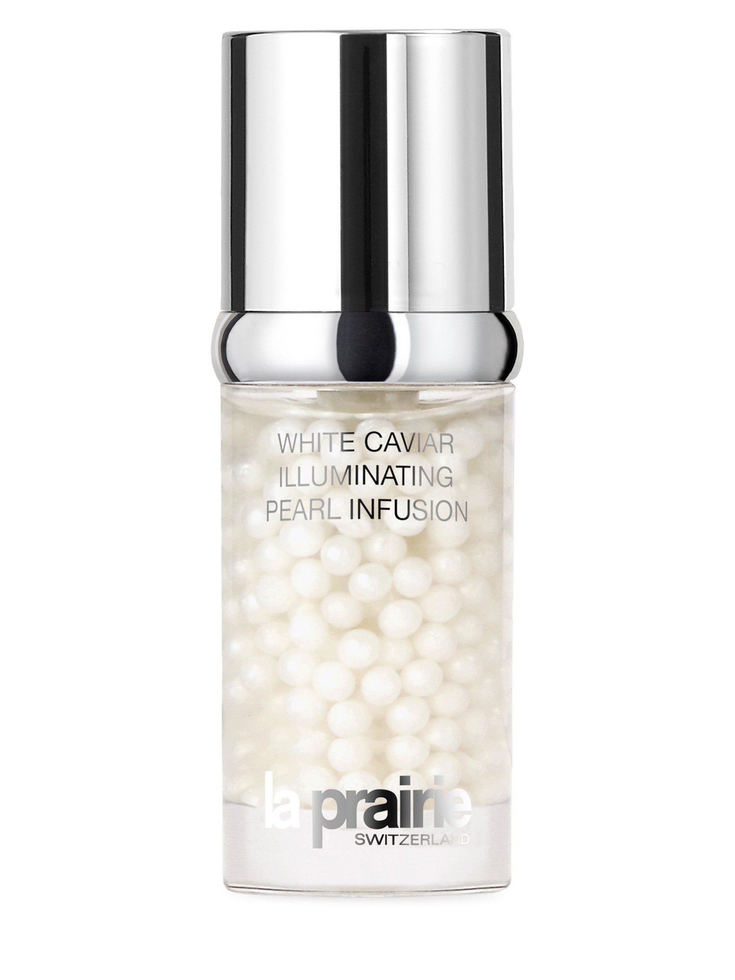 La Prairie White Caviar Illuminating Pearl Infusion in a clear glass bottle filled with small white pearls, topped with a sleek silver cap and featuring elegant branding.