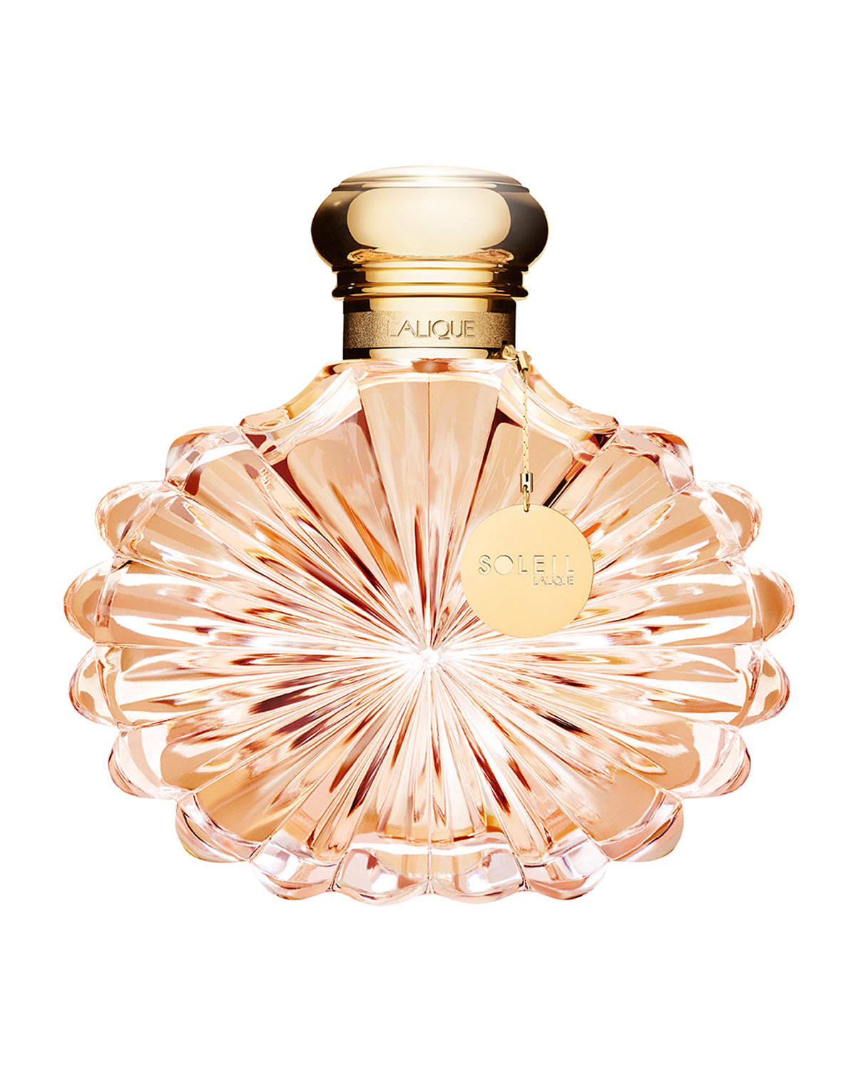 Clear glass perfume bottle with a sunburst design, featuring a gold cap and a small gold tag that reads "SOLEIL" in elegant lettering. The liquid inside is a soft pink hue.