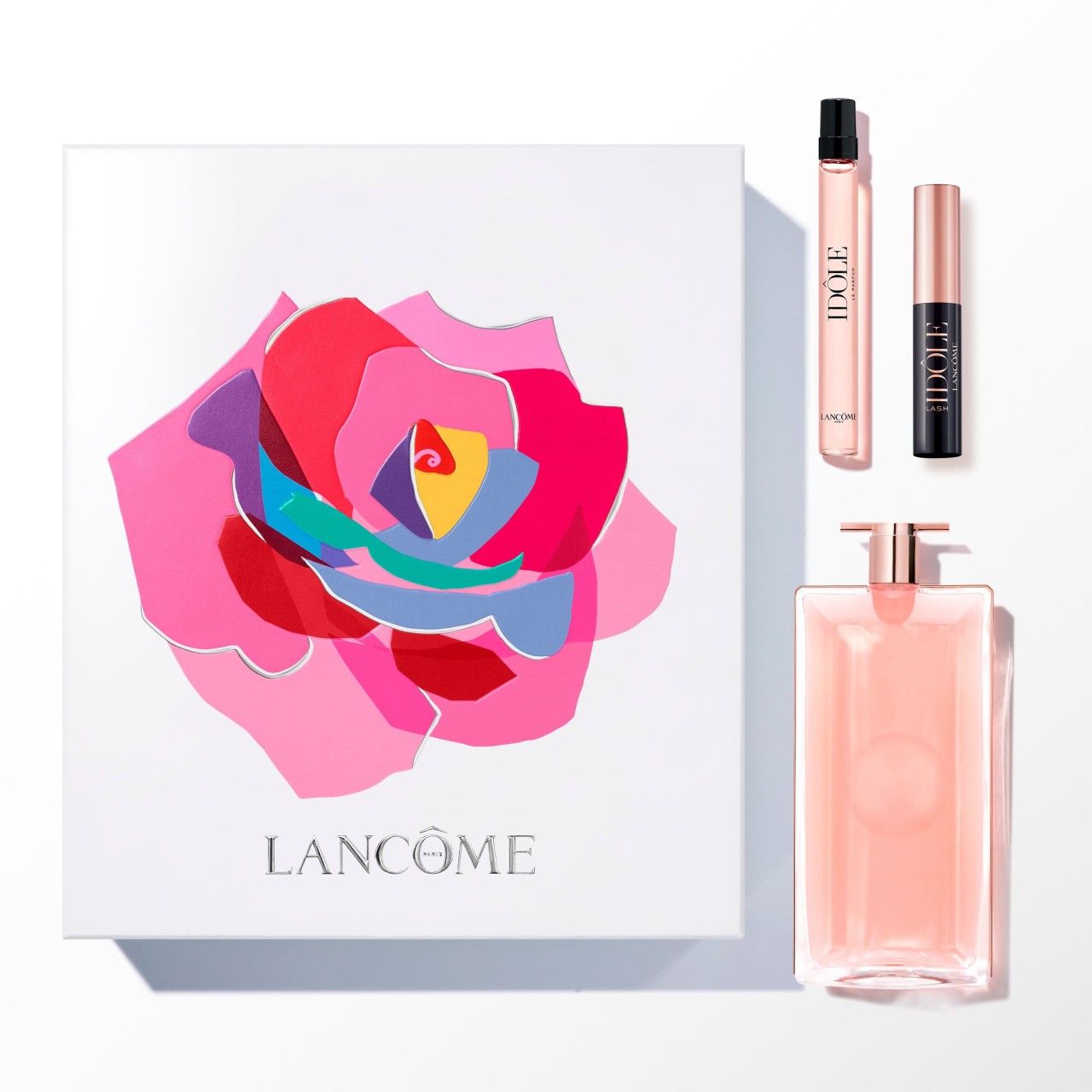 Lancôme IDôle gift set featuring a 50ml pink EDP bottle, a 10ml EDP spray, and a 2ml black Lash Idole mascara, all presented in a colorful floral box.