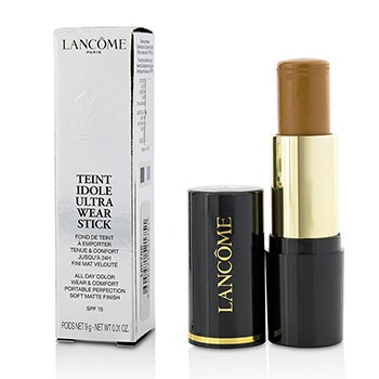 Lancôme Teint Idole Ultra Wear Foundation Stick in shade 06 Beige Cannelle, featuring a sleek black and gold tube with a twist-up applicator, alongside its elegant packaging box.