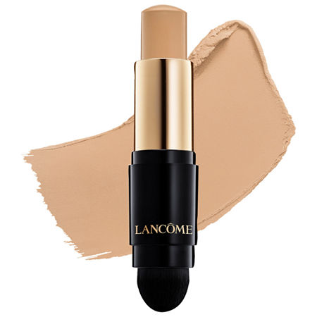 Lancôme Teint Idole Ultra Wear Foundation Stick in a sleek black and gold tube, featuring a creamy beige stick and a soft applicator tip, with a swatch of matching foundation beside it.