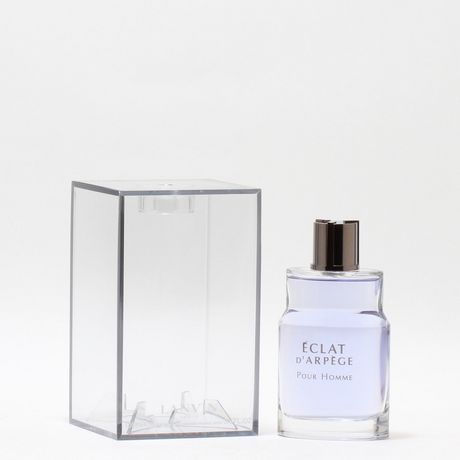 Clear rectangular box beside a glass bottle of Eclat D'Arpege Pour Homme, featuring a sleek design, purple liquid, and a silver cap.