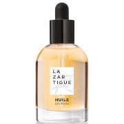 Transparent glass bottle with a black dropper cap, containing golden nourishing dry oil, labeled "LAZARTIGUE, Huile Des Rêves" in elegant white font.