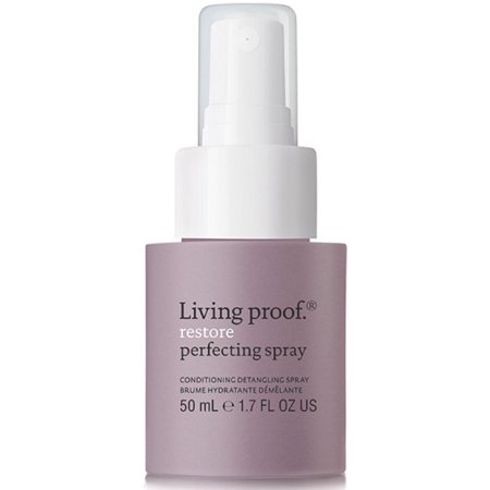 A sleek, lavender bottle of Living Proof Restorative Perfecting Spray with a white pump top, labeled with product details and a 50 ml capacity.