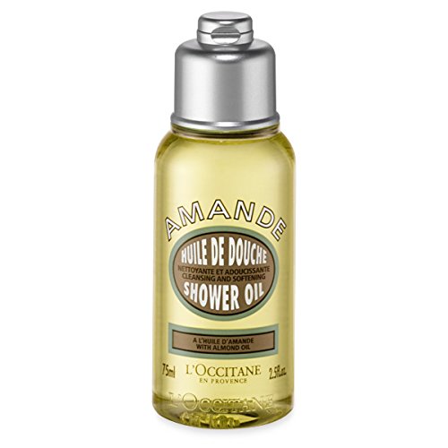Clear plastic bottle of L'Occitane Cleansing and Softening Shower Oil, featuring a silver cap, yellow liquid, and a label with "Amande" and "Shower Oil" in elegant fonts.