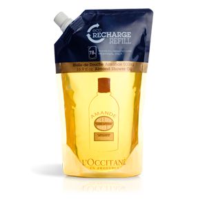 Clear pouch containing 16.9 oz of L'Occitane Eco-Refill Almond Cleansing & Softening Shower Oil, featuring a yellow liquid and a blue top with "Recharge Refill" label.