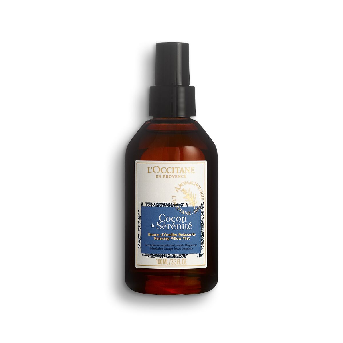 L'OCCITANE Aromachologie Cocon De Sérenité Relaxing Pillow Mist in a dark amber glass bottle with a black spray nozzle and a blue and white label featuring floral designs.