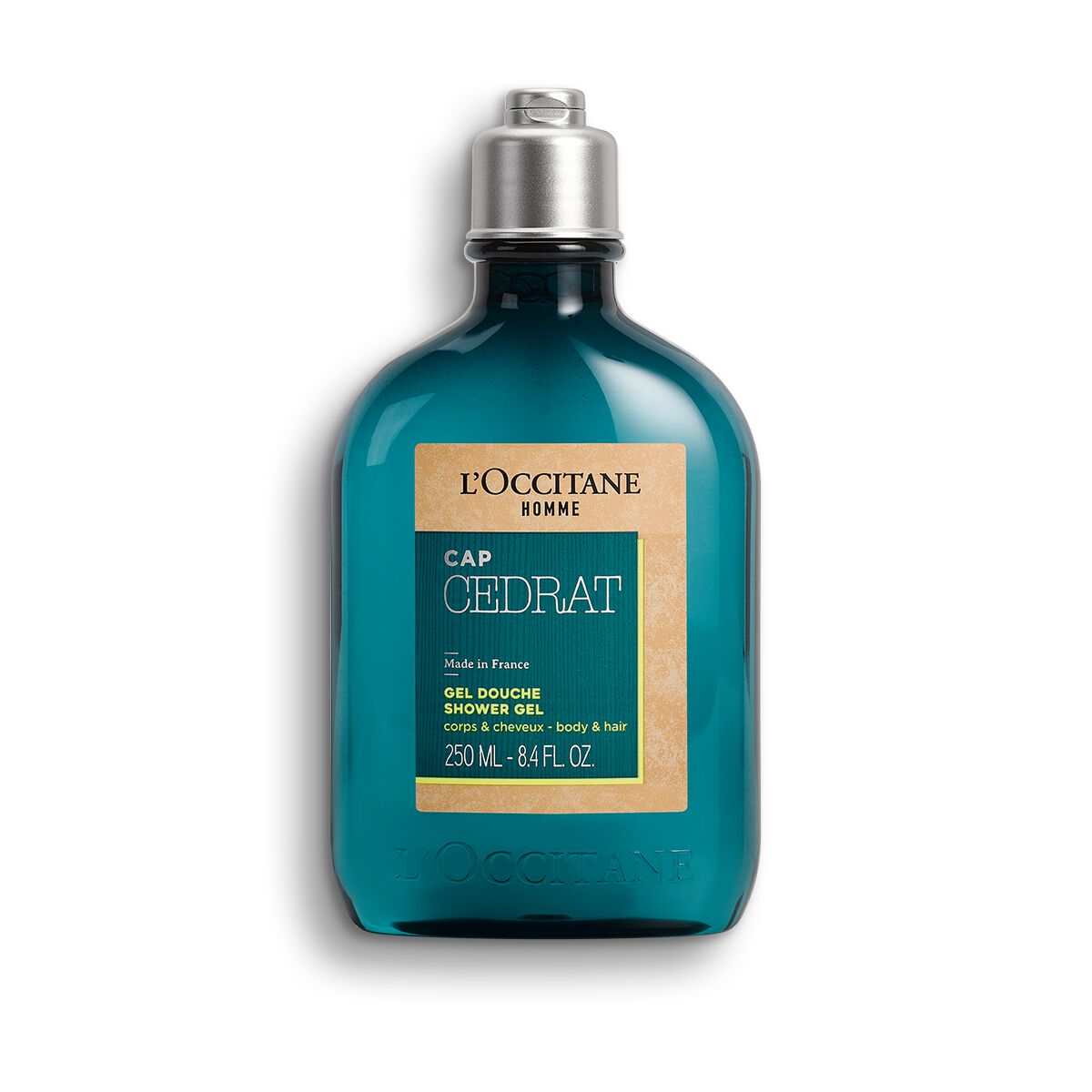 Teal glass bottle with a silver cap, featuring a beige label that reads "L'Occitane - Cap Cedrat Shower Gel 8.4 Fl Oz" in bold lettering.