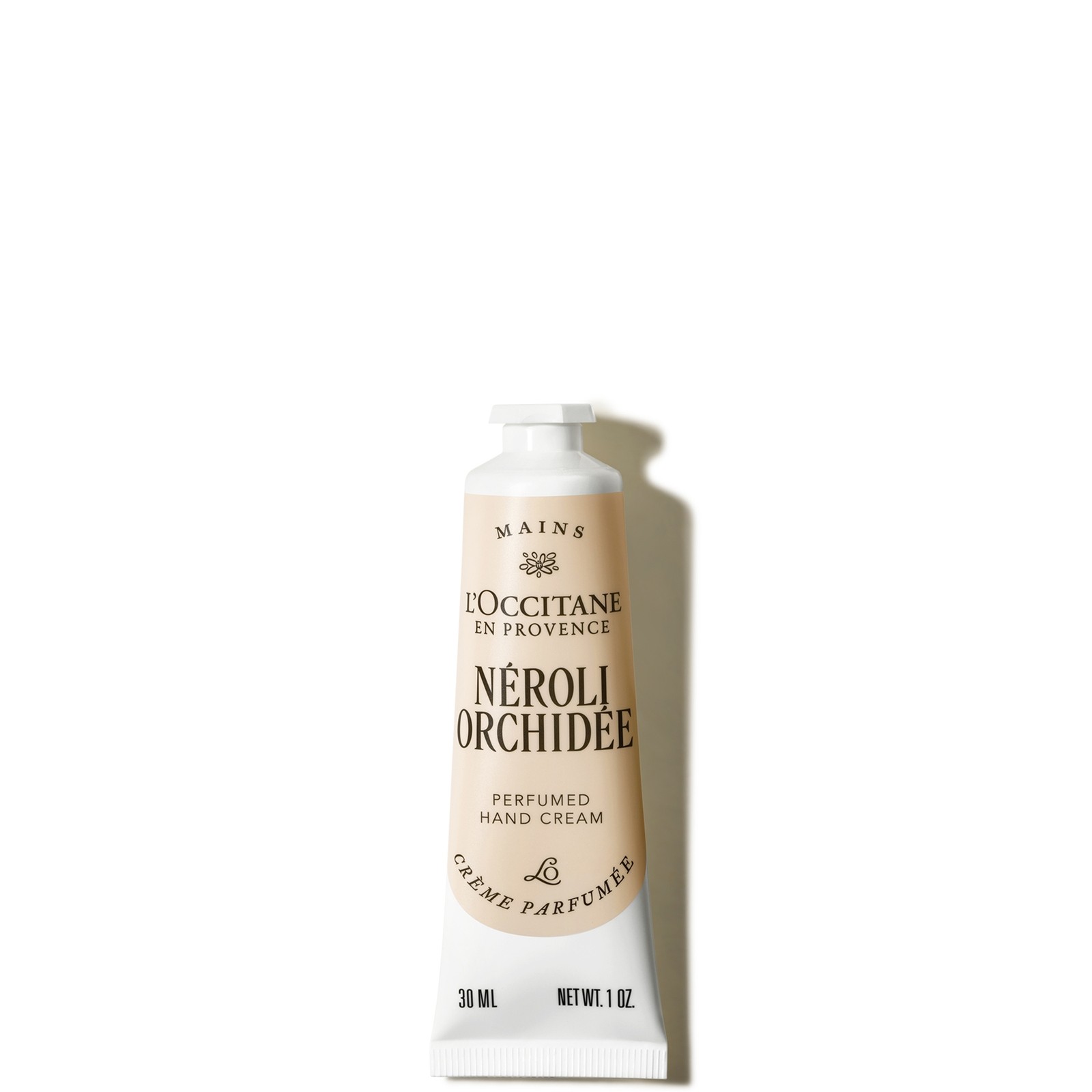 L'Occitane Néroli & Orchidée Hand Cream in a 30ml metal tube, featuring a soft beige color with elegant black text and floral accents, showcasing its luxurious and fragrant formula.