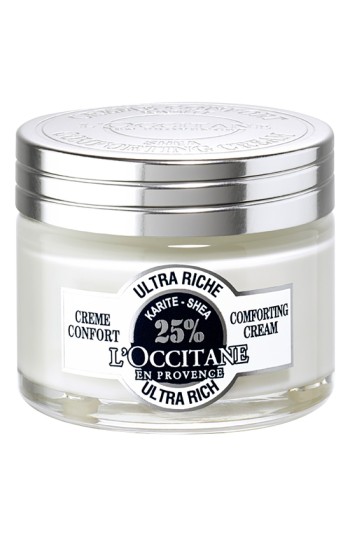 White glass jar with a silver metal lid, labeled "L'Occitane Ultra Rich Comforting Cream," featuring a black and white design and stating "25% Shea Butter" prominently.