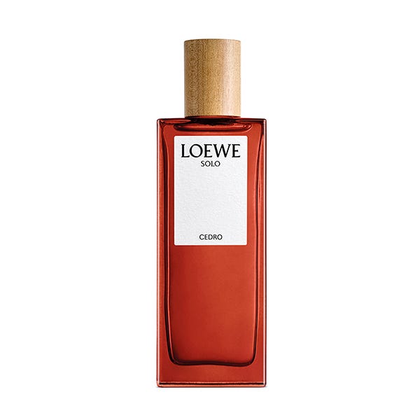 Loewe Solo Cedro Eau De Toilette Spray for Men in a rectangular glass bottle with a rich red hue, topped with a natural wood cap and featuring a minimalist white label.
