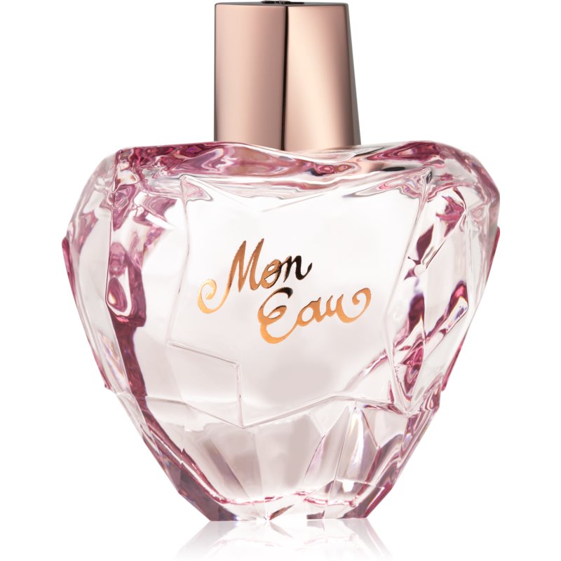 Clear, heart-shaped glass bottle with a pink tint, featuring a gold cap and the elegant script "Mon Eau" in gold lettering on the front.
