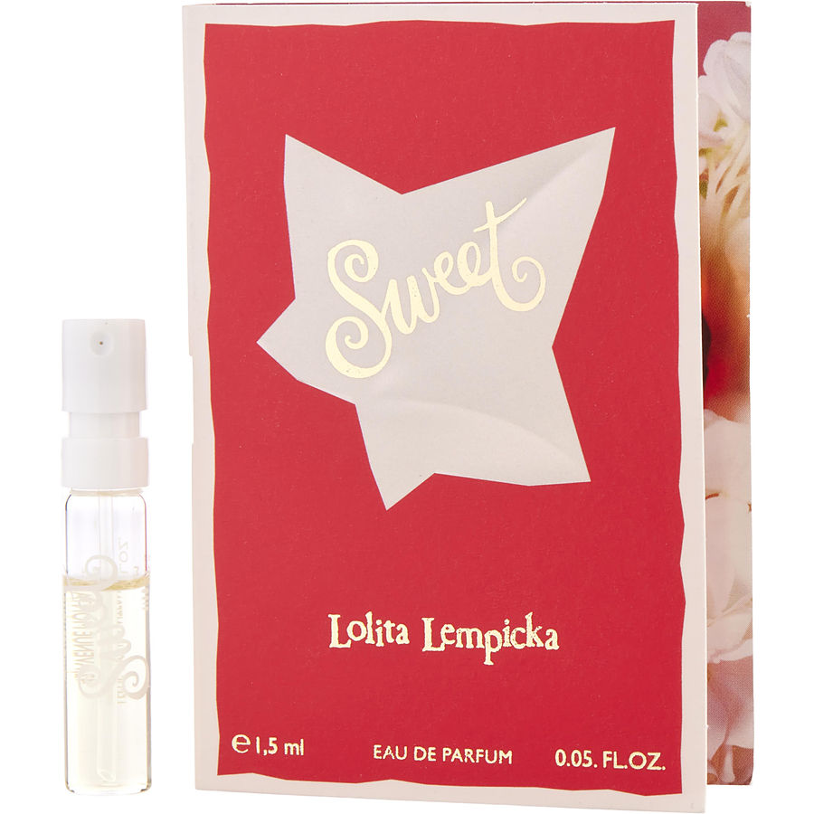 Clear glass spray vial of "Lolita Lempicka Sweet" Eau de Parfum, with a red box featuring a white star and floral design, labeled with brand and fragrance name.