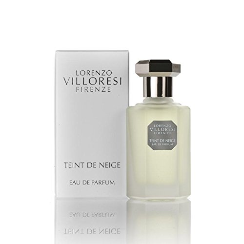 Clear glass bottle with a sleek design, silver cap, and a label reading "Teint De Neige" in elegant font, accompanied by a white box featuring the brand name "Lorenzo Villoresi."