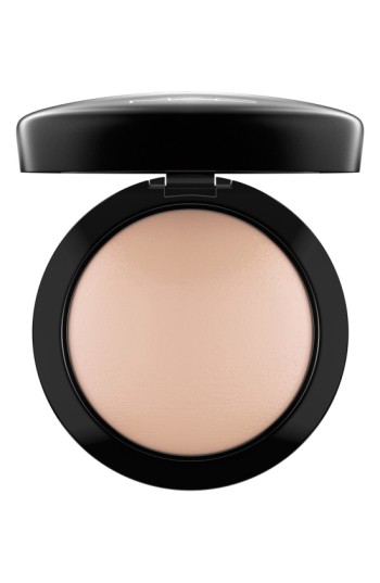 Round compact with a glossy black lid, containing a smooth, light beige powder, labeled "Mineralize Skinfinish Natural" in the center.