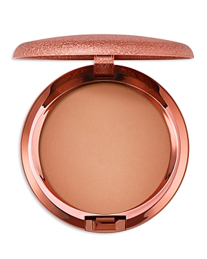 Round compact featuring a light golden matte bronzer, encased in a rose gold metallic shell with a smooth finish and a secure clasp.
