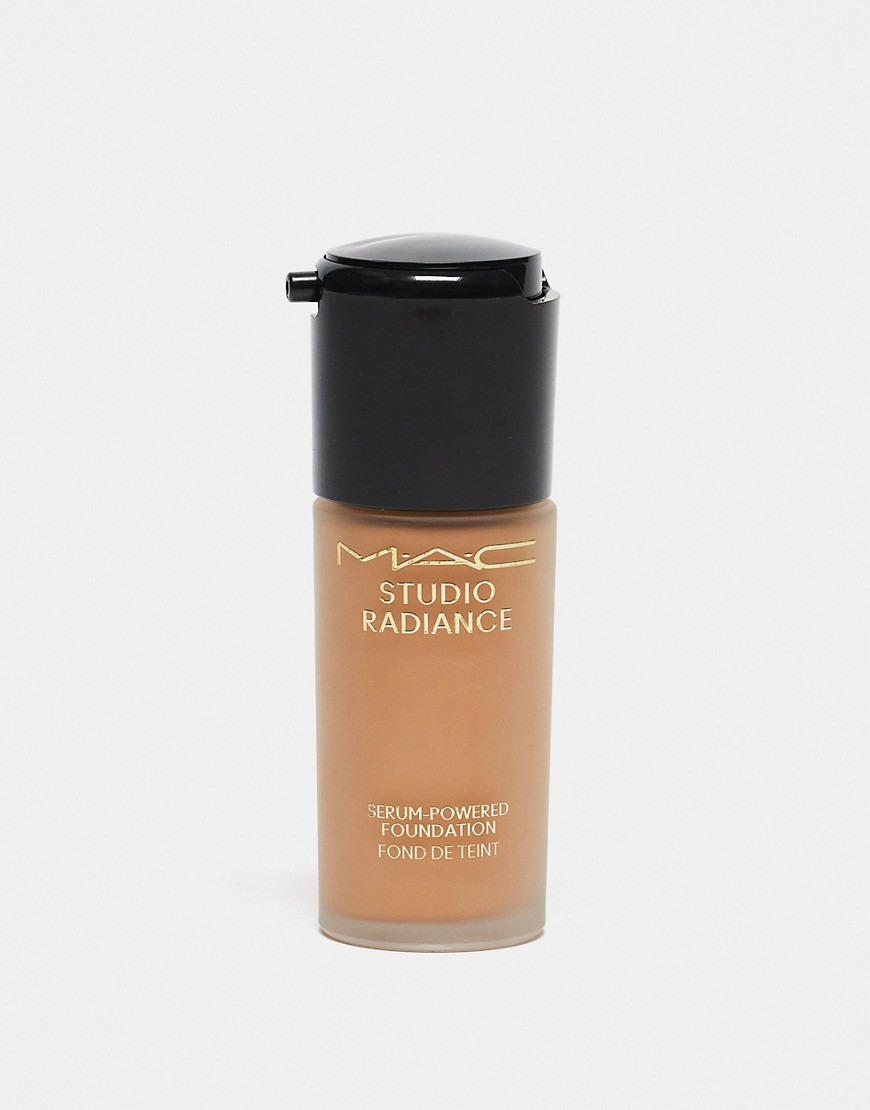 MAC Studio Radiance Serum-Powered Foundation in shade N32, featuring a sleek glass bottle with a black pump top and gold lettering on a beige background.