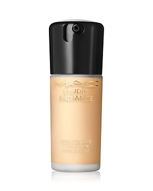 MAC Studio Radiance Serum-Powered Foundation in shade NC20, featuring a sleek glass bottle with a black pump top and gold lettering on a light beige liquid foundation.