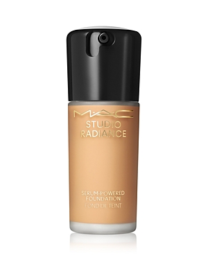MAC Studio Radiance Serum Powered Foundation in a sleek, clear glass bottle with a black pump top, showcasing a warm beige liquid inside.