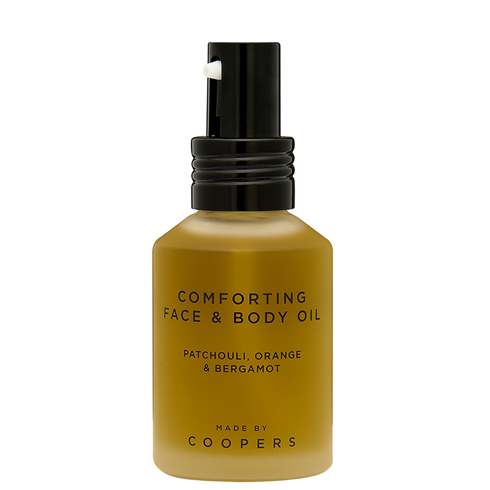 Amber glass bottle with a black pump top, labeled "Comforting Face & Body Oil" featuring notes of patchouli, orange, and bergamot, 60ml size, designed for women.