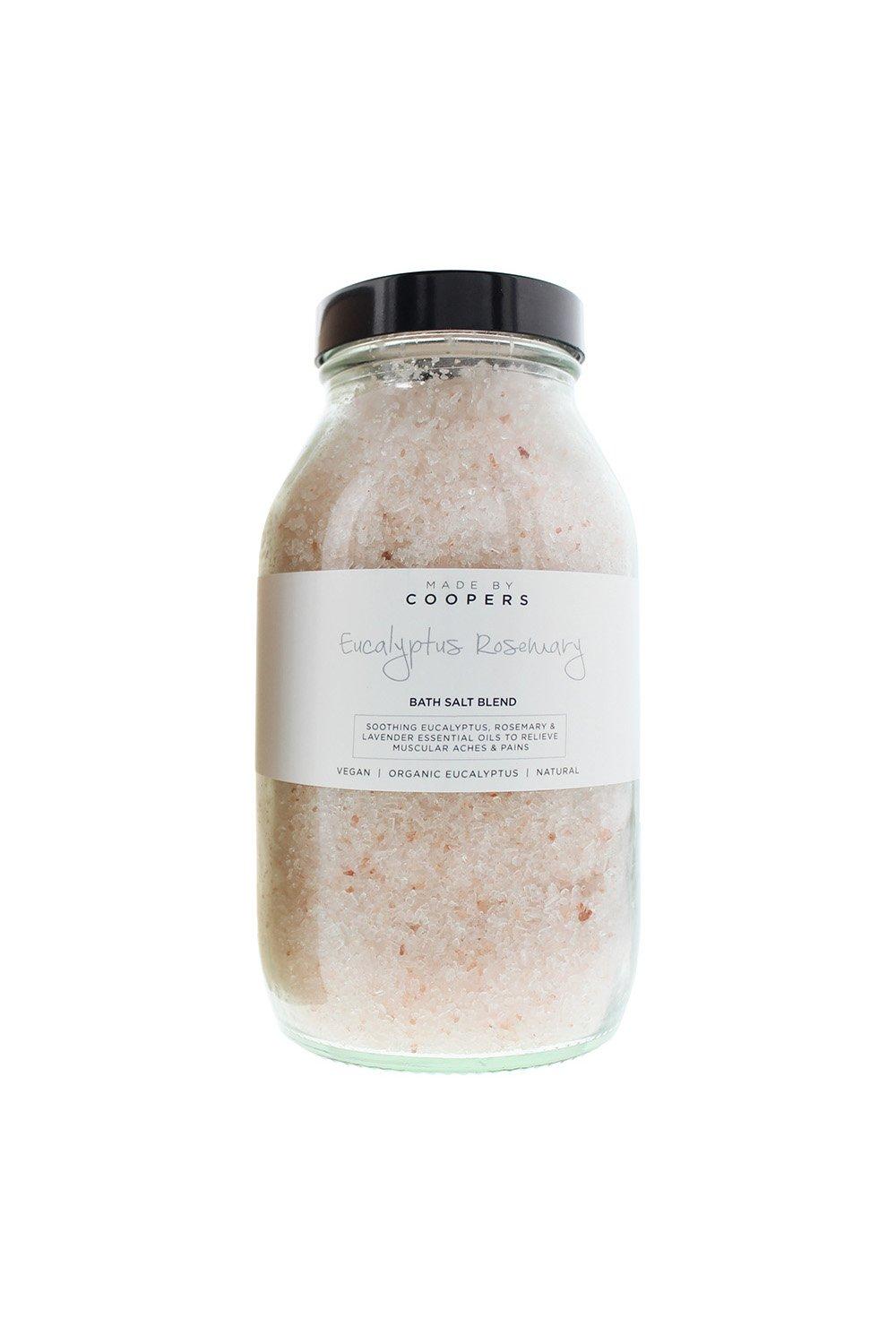 Clear glass jar filled with pink bath salts, labeled "Eucalyptus Rosemary" in black text, featuring a white band and a black lid, showcasing a natural and organic aesthetic.