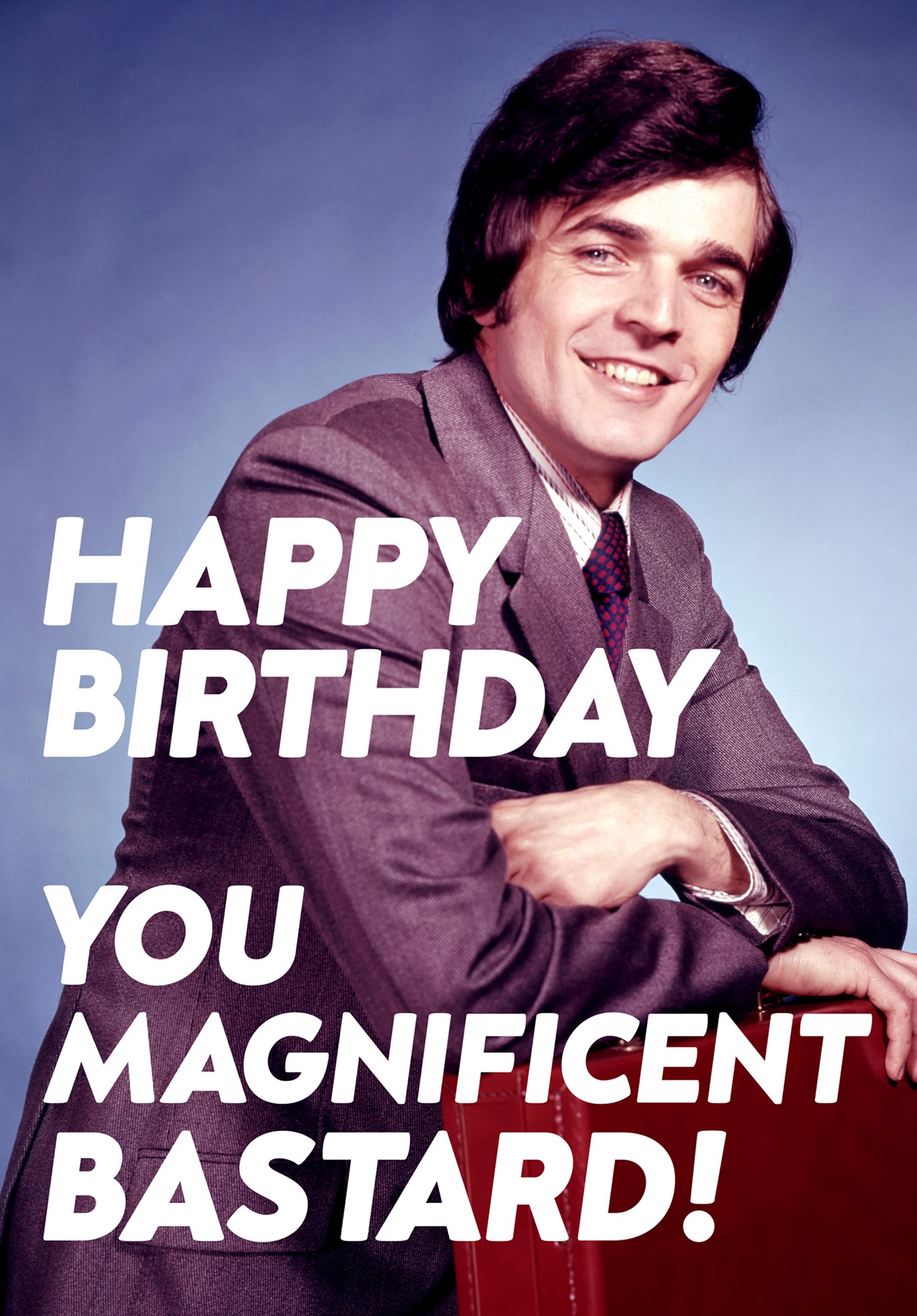 A birthday card featuring a smiling man in a gray suit with a patterned tie, set against a blue background, with bold white text reading "HAPPY BIRTHDAY YOU MAGNIFICENT BASTARD!"