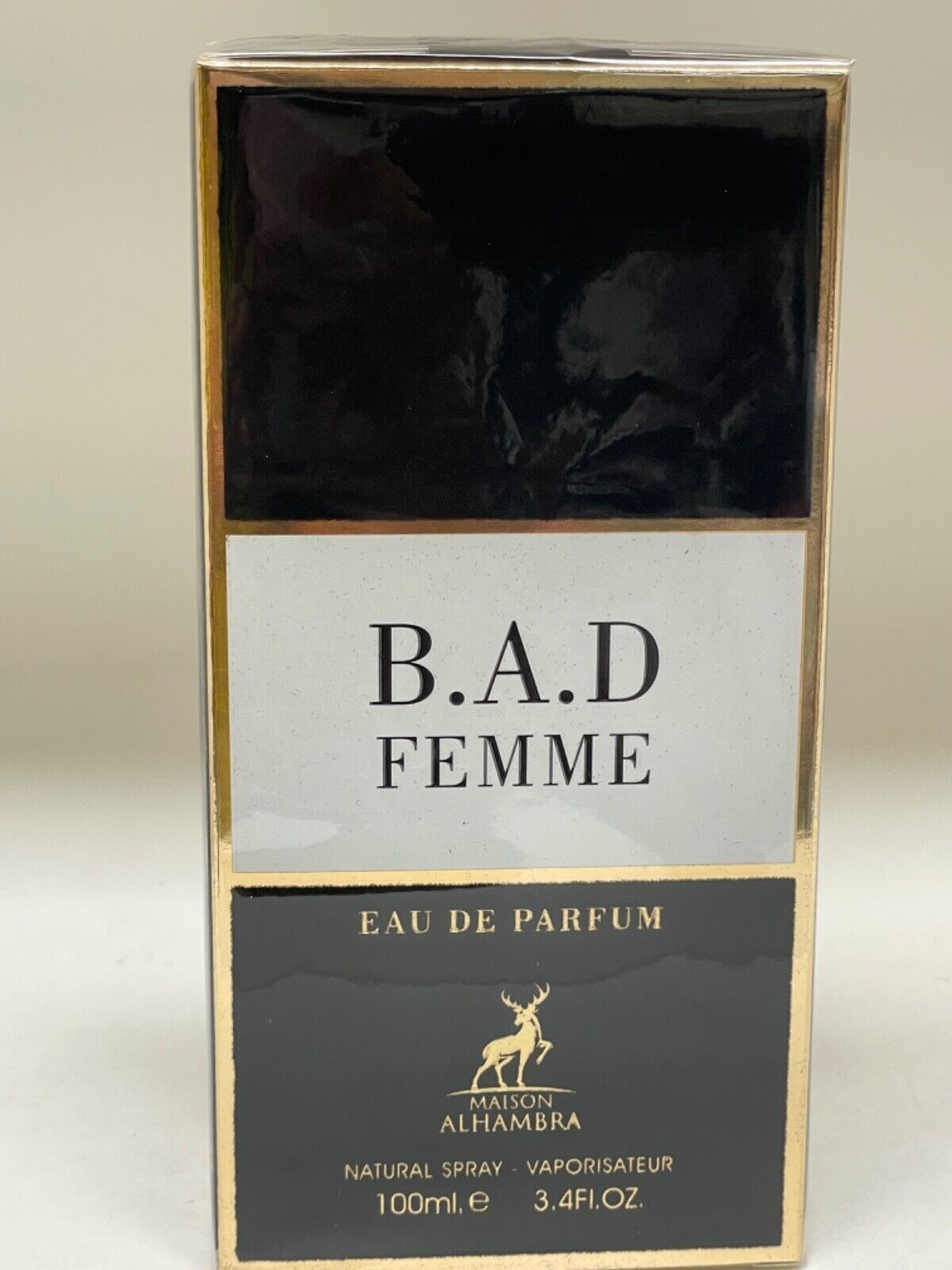 Black and gold rectangular box featuring the text "B.A.D. FEMME" prominently displayed on a white label, with "EAU DE PARFUM" and brand name "MAISON ALHAMBRA" at the bottom.