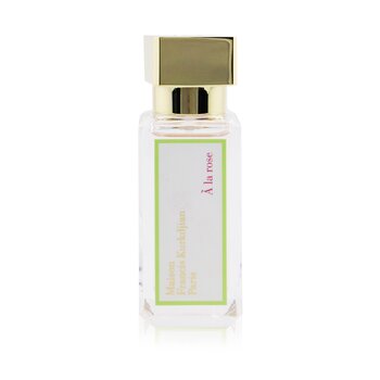 Clear glass bottle with a gold cap, featuring a green label that reads "Maison Francis Kurkdjian La Rose Eau De Parfum" in elegant font.