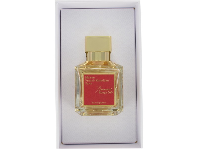 Clear glass bottle with a gold cap, featuring a red label that reads "Baccarat Rouge 540" and "Maison Francis Kurkdjian Paris," presented in a white box.