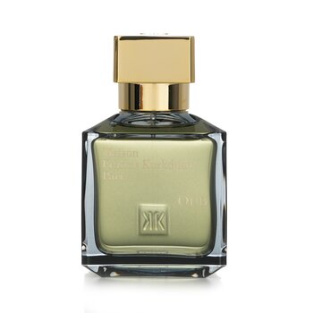 Clear glass bottle with a gold square cap, featuring a greenish liquid inside, embossed logo on the front, and elegant, minimalist design.