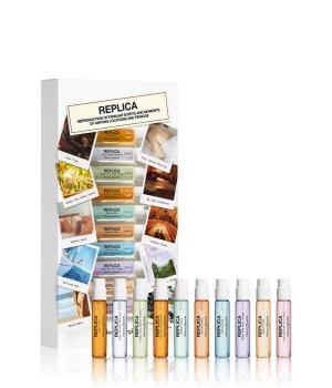 Maison Margiela Memory Box gift set featuring ten 2ml Eau De Toilette vials in various pastel colors, displayed in a sleek white box with a vintage-style label and scenic imagery.
