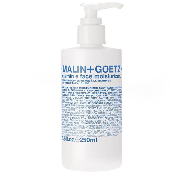 White plastic pump bottle labeled "Malin + Goetz Vitamin E Face Moisturizer," featuring blue text and a sleek, minimalist design, holding 8.5 fl oz (250 ml).