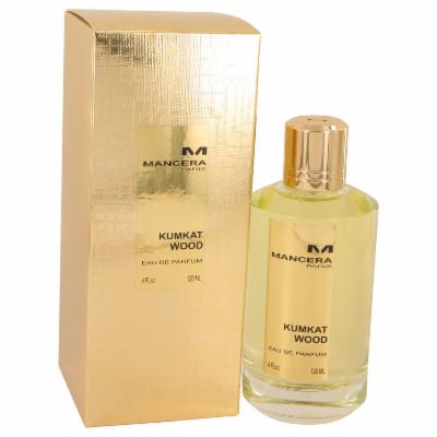 Kumkat Wood Eau De Parfum Spray by Mancera, 4 oz, features a clear glass bottle with a gold cap, presented in a shiny gold box with the brand logo prominently displayed.