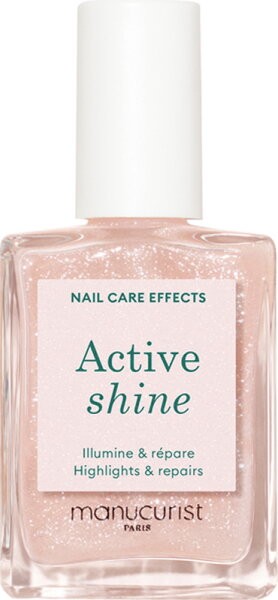 Clear glass bottle containing a light pink nail treatment with a white cap, featuring a label that reads "Active shine" in green text, highlighting its illuminating and repairing properties.