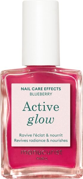 Bright fuchsia nail polish in a glass bottle with a square shape, featuring a white label that reads "Active Glow" and "Blueberry" by Manucurist.