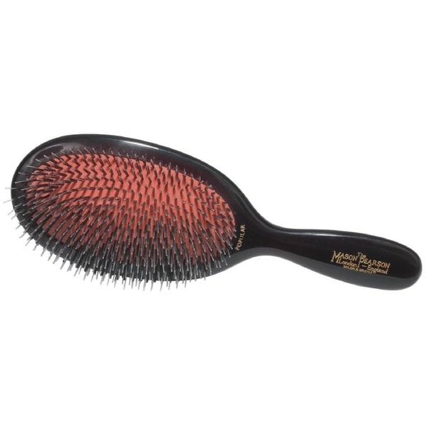 Black Mason Pearson pocket hair brush featuring a mix of bristle and nylon bristles, with a curved handle and a distinctive red cushion base.
