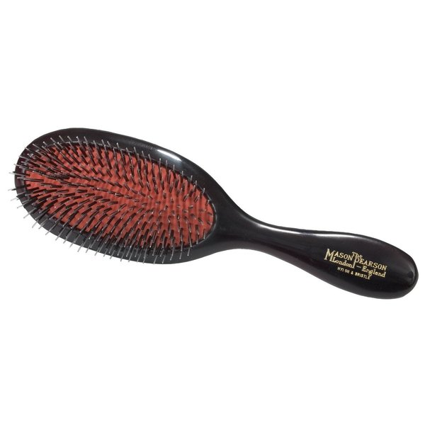 Handy hairbrush featuring a dark ruby bristle and nylon design, with a sleek black handle and gold lettering of the Mason Pearson brand.