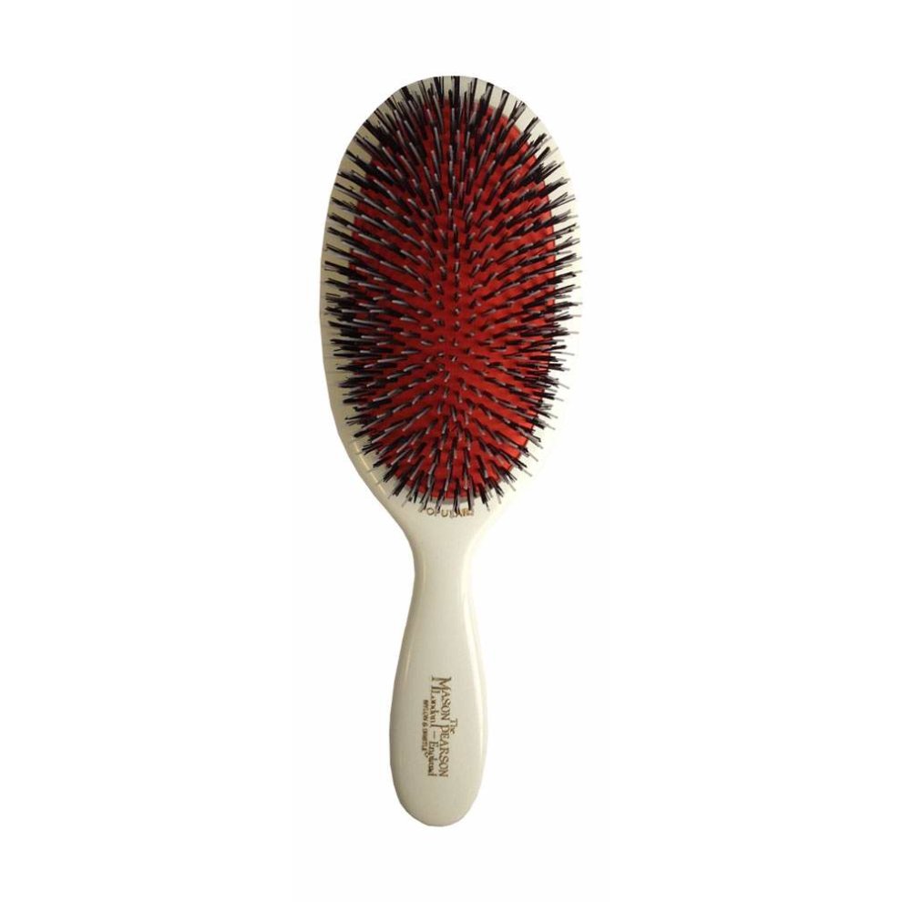Large oval hairbrush featuring a white handle, a mix of black nylon and natural bristles, and a distinctive red cushion base, designed for effective grooming.