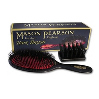 Mason Pearson B1 hairbrush in dark ruby with pure bristles, featuring a black handle and a matching display stand, packaged in a gold and black box.